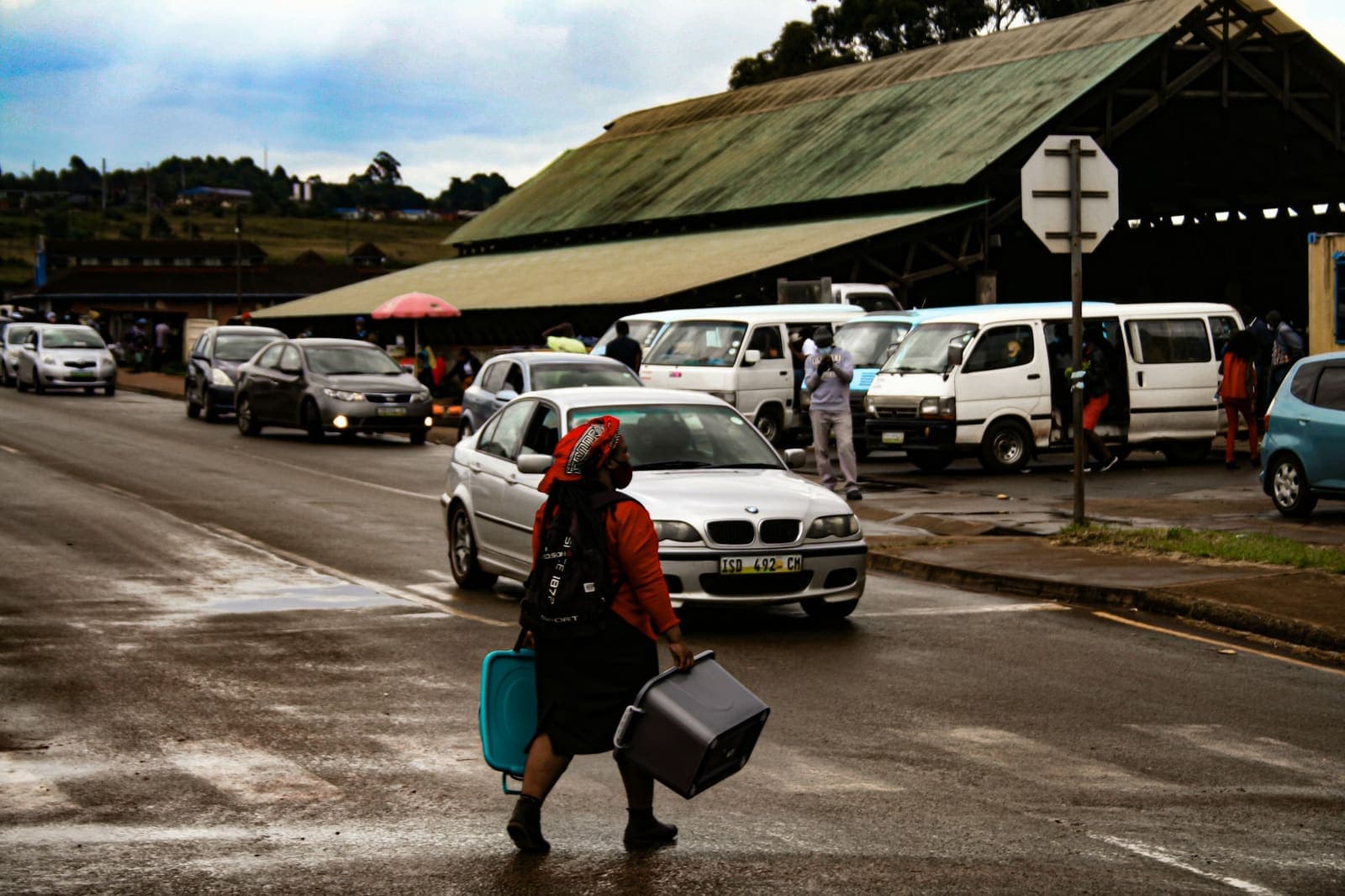 Street scene with parked vans and pedestrians in Nhlangano, Eswatini