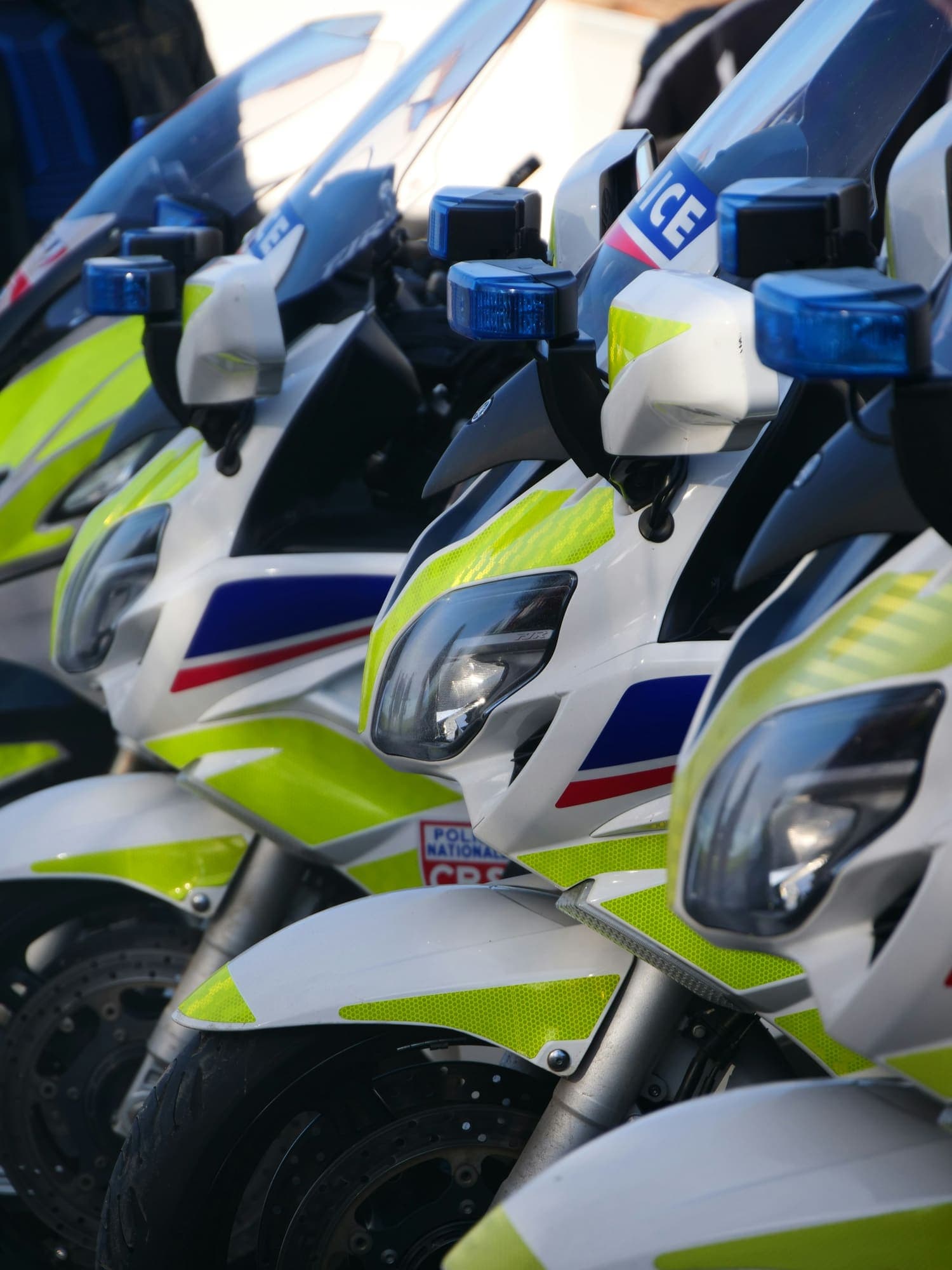 Several police motorcycles lined up in a row at an enforcement post