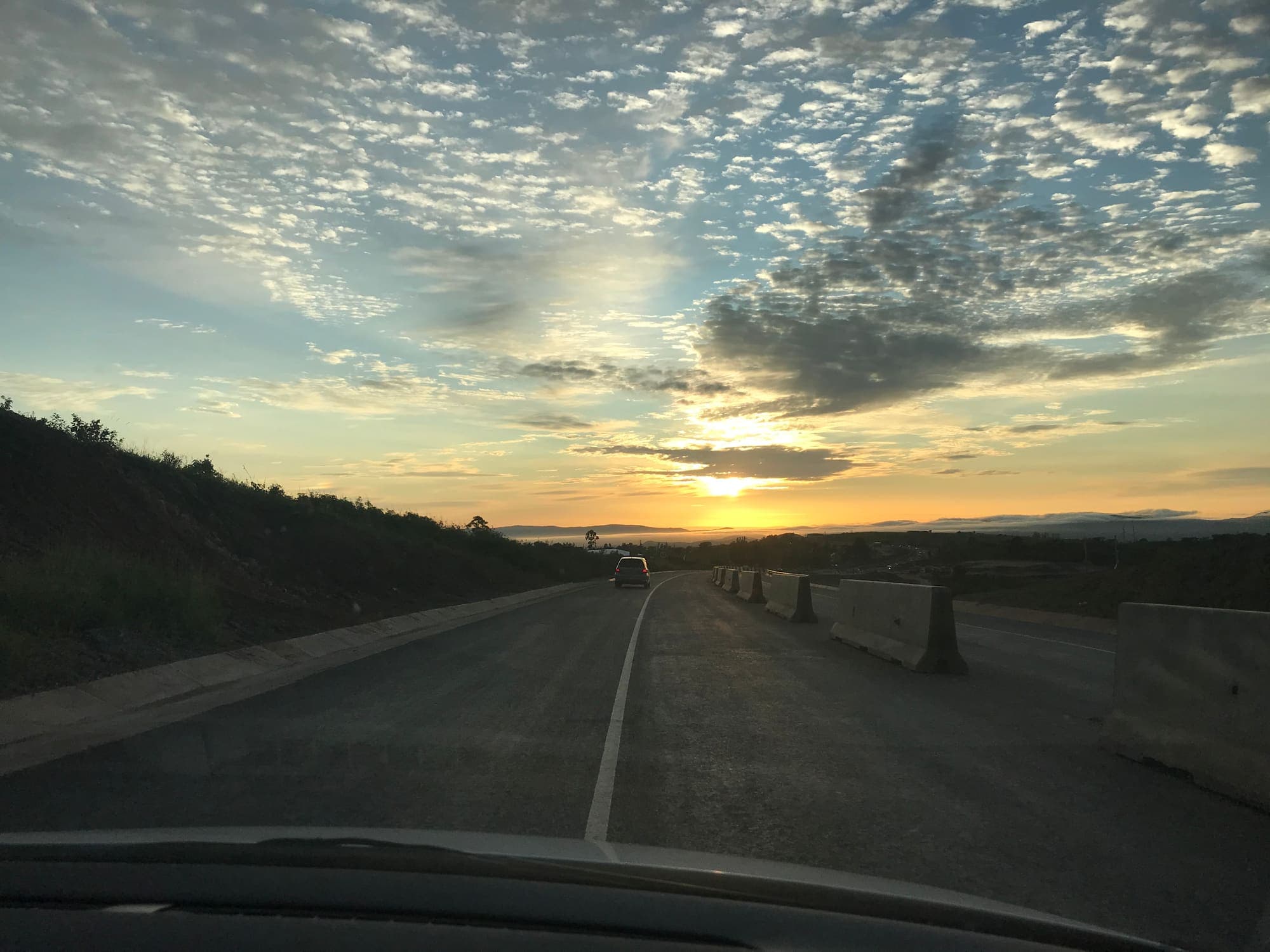 Eswatini road at sunrise with active road works in progress